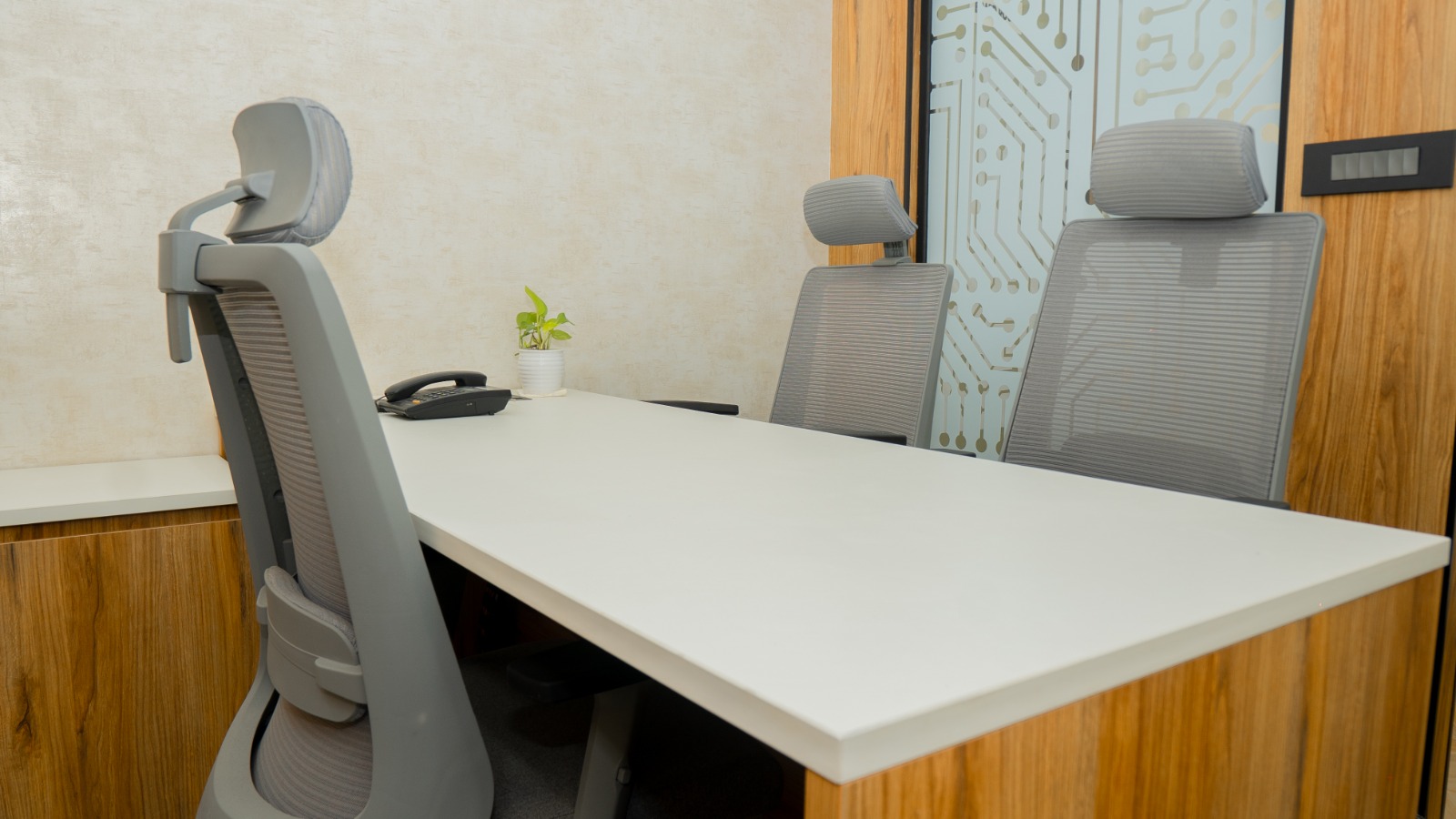 Director cabin seating area with wood laminate wall panelling in Valorium Ventures office interior