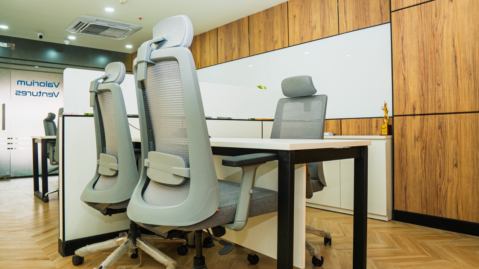 Supervisor desk with storage and neutral finishes in Valorium Ventures office interior