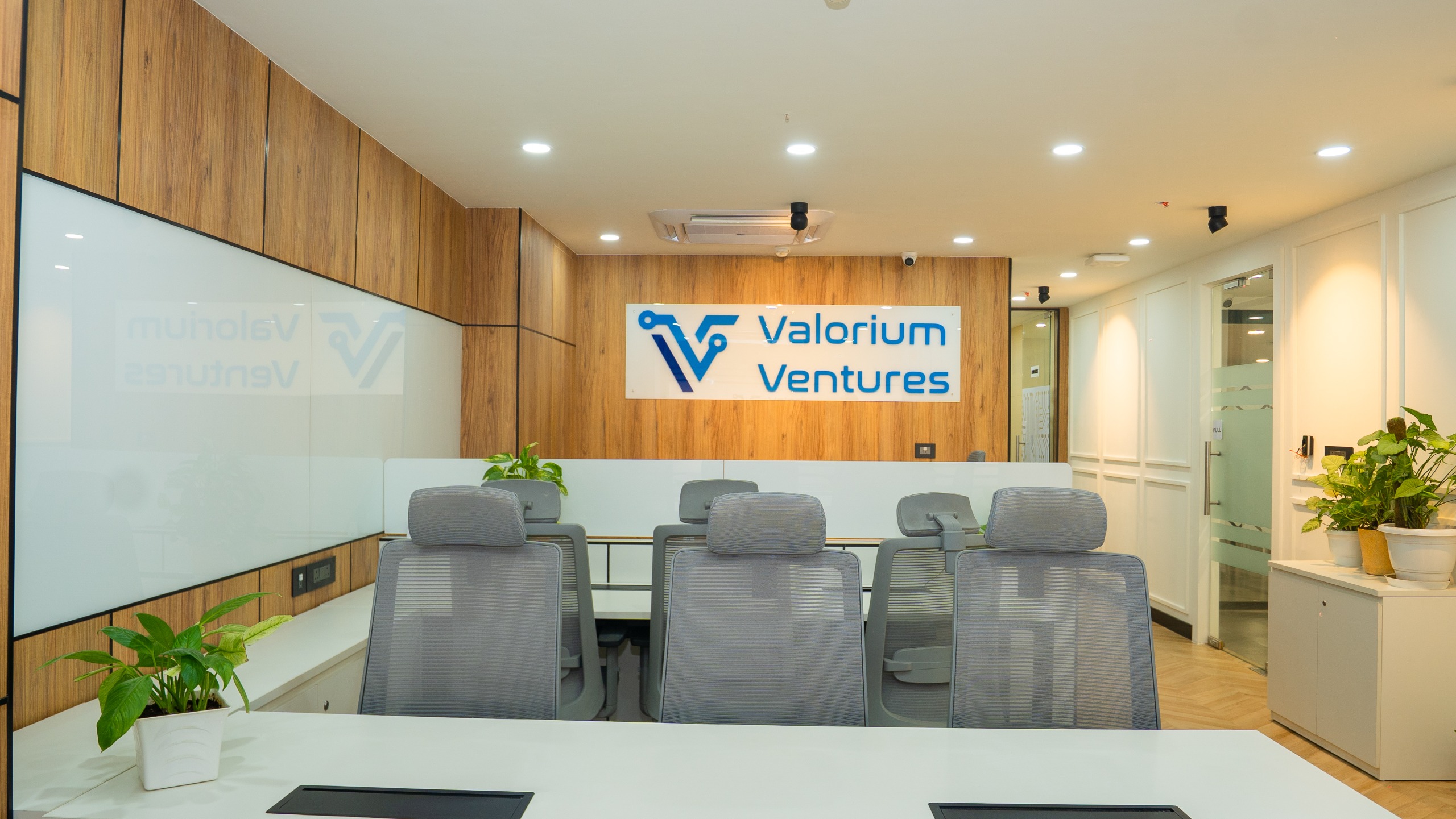 Open workstation area with linear desks and overhead lighting at Valorium Ventures office interior