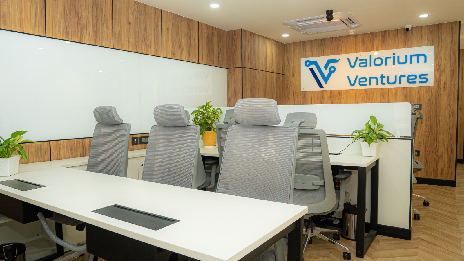 Workstation area showing circulation space and neutral palette interior at Valorium Ventures office interior