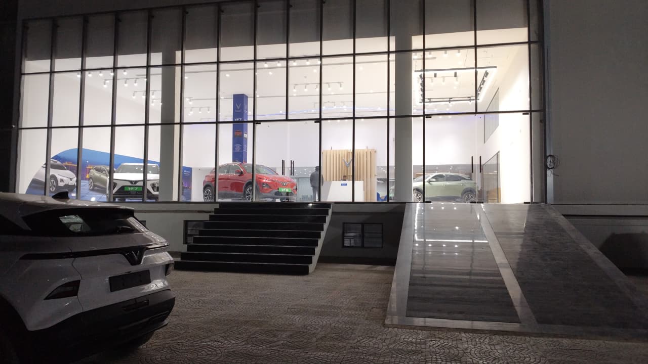 Parking area at VinFast showroom with vehicle ramp and parking bays